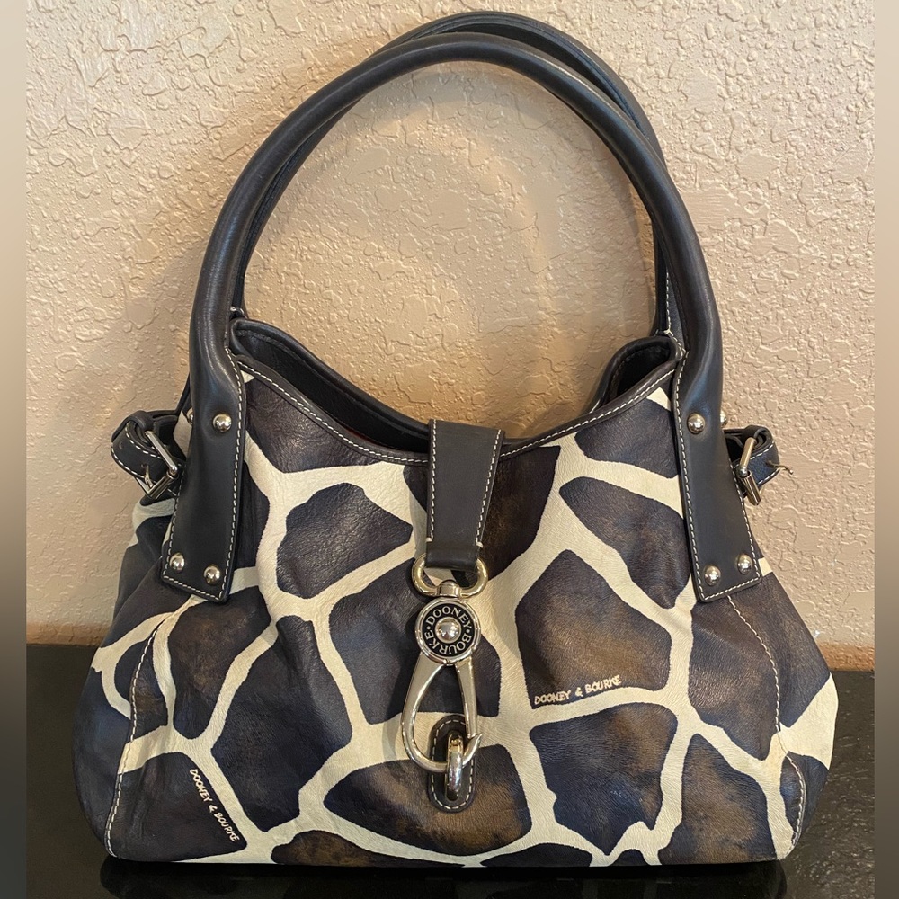 Dooney & Bourke , like new. 13 1/2” W, 9” H, , 16 1/2” H w/ strap, 7” D. AS IS